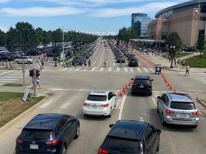Event traffic operations Nashville TN | Nashville Civil Engineering Heavy event traffic with vehicles, pedestrians, crosswalks, and temporary traffic cones near a venue in Nashville, TN.